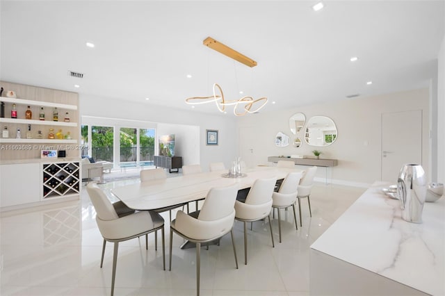 dining space with an inviting chandelier and light tile patterned floors