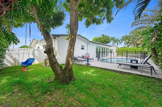 back of house with a patio, a lawn, and a fenced in pool