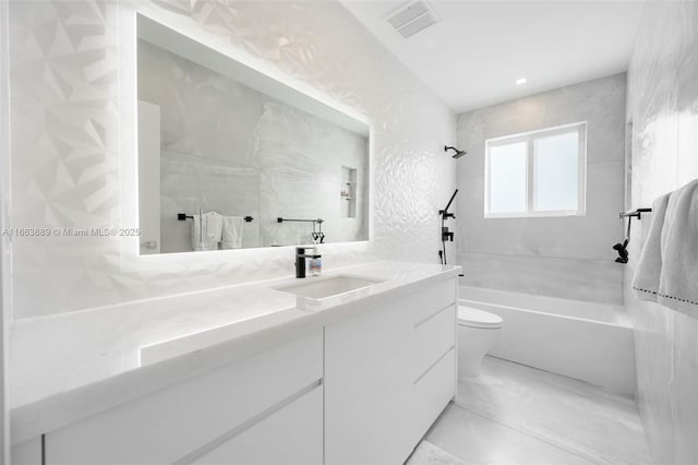 full bathroom featuring toilet, vanity, and tiled shower / bath