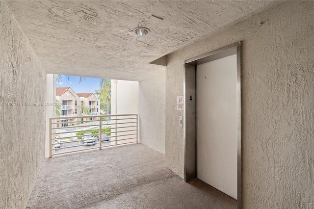 corridor featuring elevator and carpet flooring