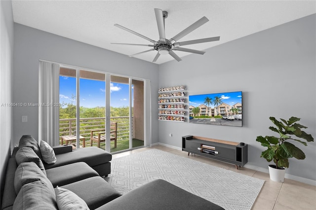 tiled living room with a textured ceiling, plenty of natural light, and ceiling fan