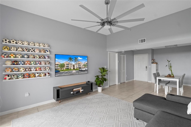 living room featuring light tile patterned floors and ceiling fan