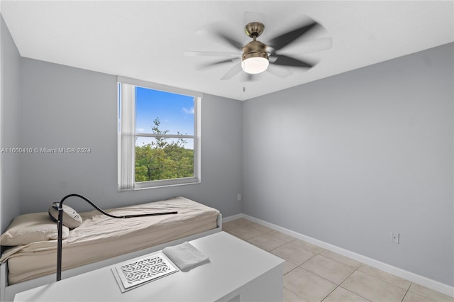 unfurnished bedroom featuring ceiling fan and light tile patterned flooring