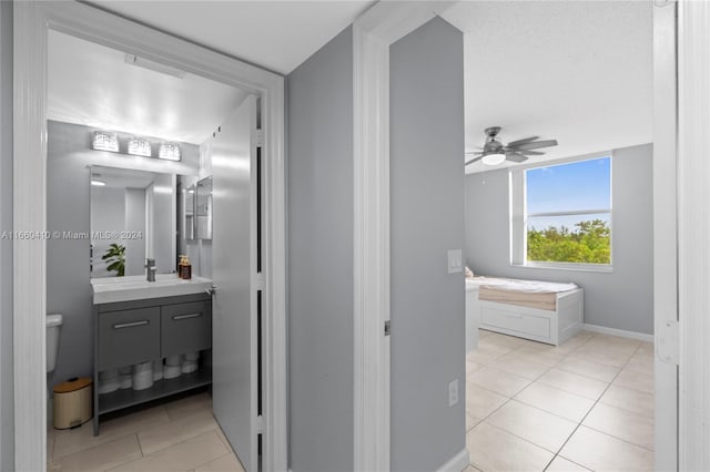 bathroom with vanity, toilet, tile patterned floors, and ceiling fan