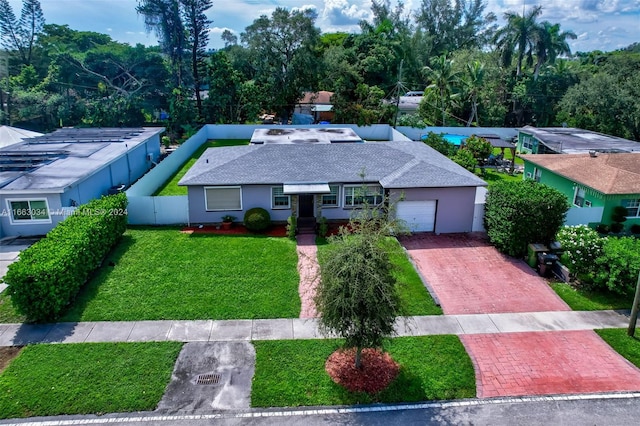 single story home featuring a front lawn and a garage