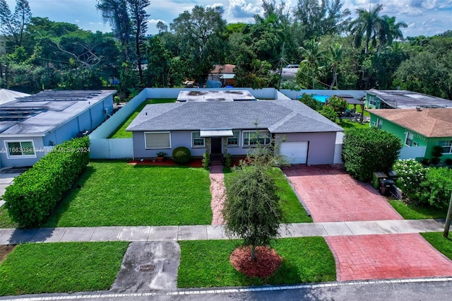 540 NE 142nd St, North Miami, FL 33161 - ranch-style home featuring an attached garage, decorative driveway, stucco siding, and a shingled roof