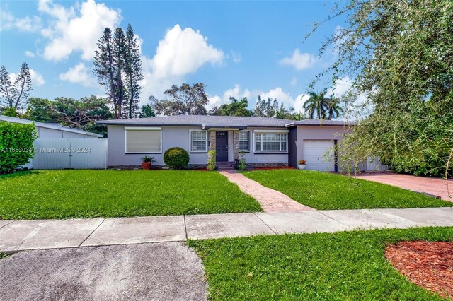 540 NE 142nd St, North Miami, FL 33161 - ranch-style home with stucco siding, an attached garage, and driveway
