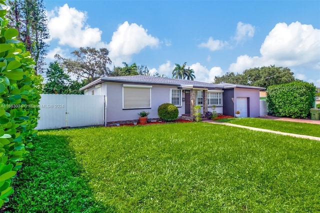 view of front of house with a front yard and a garage