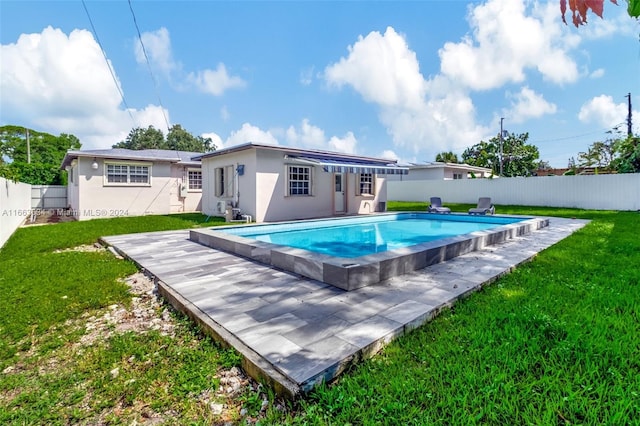 view of swimming pool with a lawn