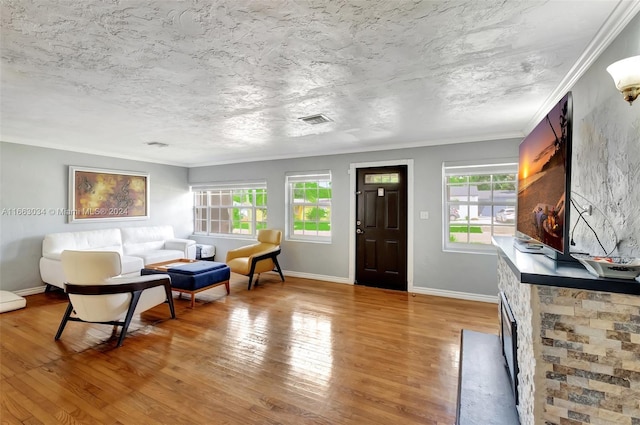 living room with plenty of natural light, a fireplace, and hardwood / wood-style flooring