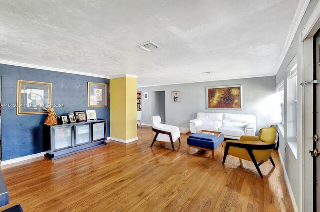 540 NE 142nd St, North Miami, FL 33161 - living area featuring light wood-style floors, baseboards, and ornamental molding