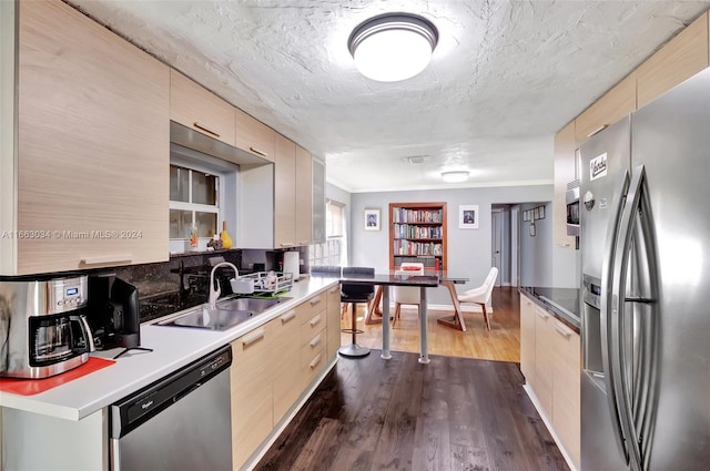 kitchen featuring a textured ceiling, dark wood-type flooring, sink, appliances with stainless steel finishes, and light brown cabinetry