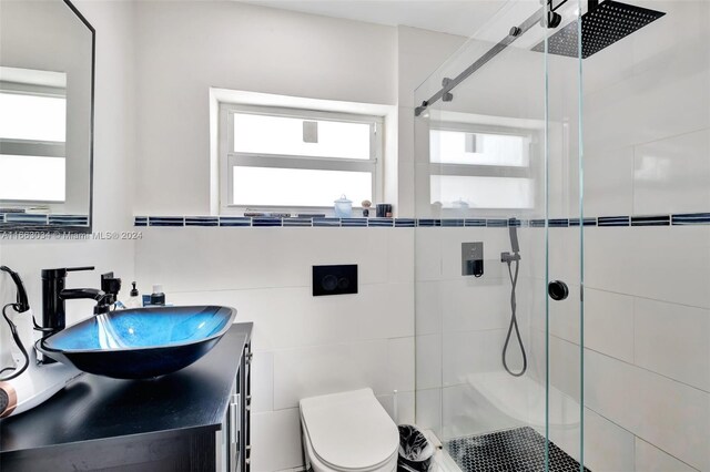 540 NE 142nd St, North Miami, FL 33161 - bathroom featuring a tile shower, toilet, plenty of natural light, and vanity