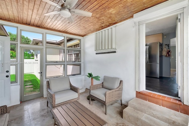 sunroom with wood ceiling and ceiling fan