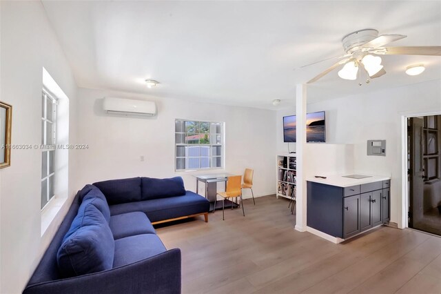540 NE 142nd St, North Miami, FL 33161 - living area with a wall unit AC, ceiling fan, and light wood-type flooring