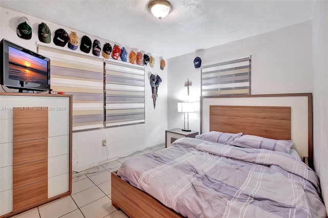 bedroom with light tile patterned floors