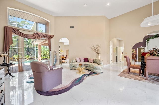 living room featuring high vaulted ceiling