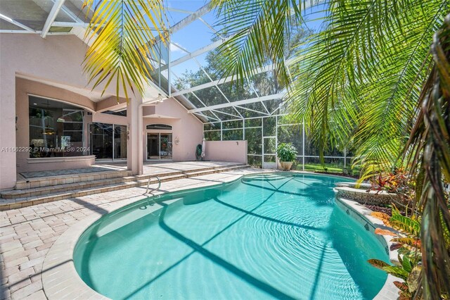 view of pool featuring a patio and a lanai