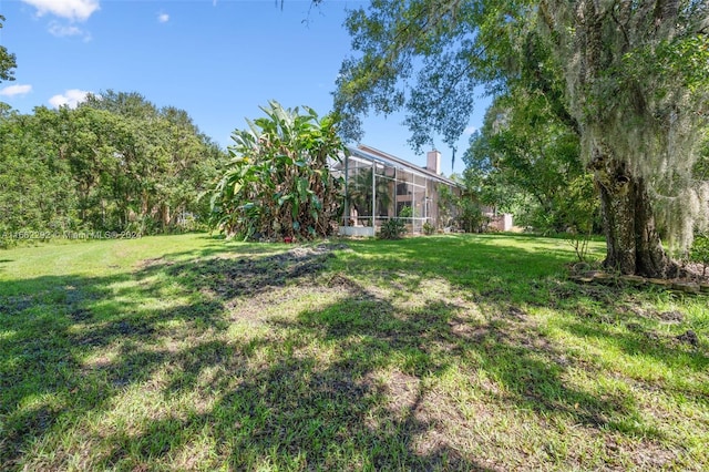 view of yard with a lanai