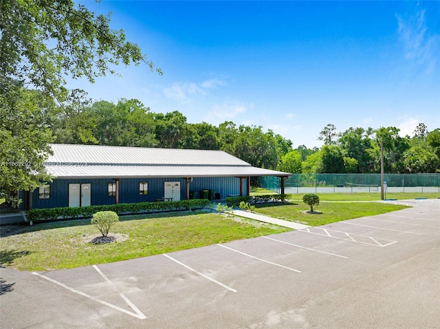 view of parking with a lawn