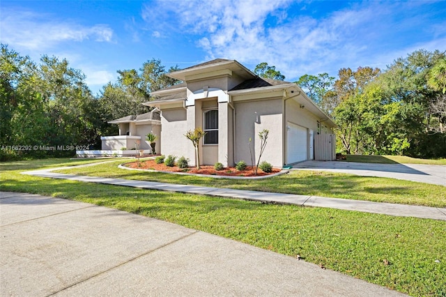 view of front of property with a garage and a front lawn