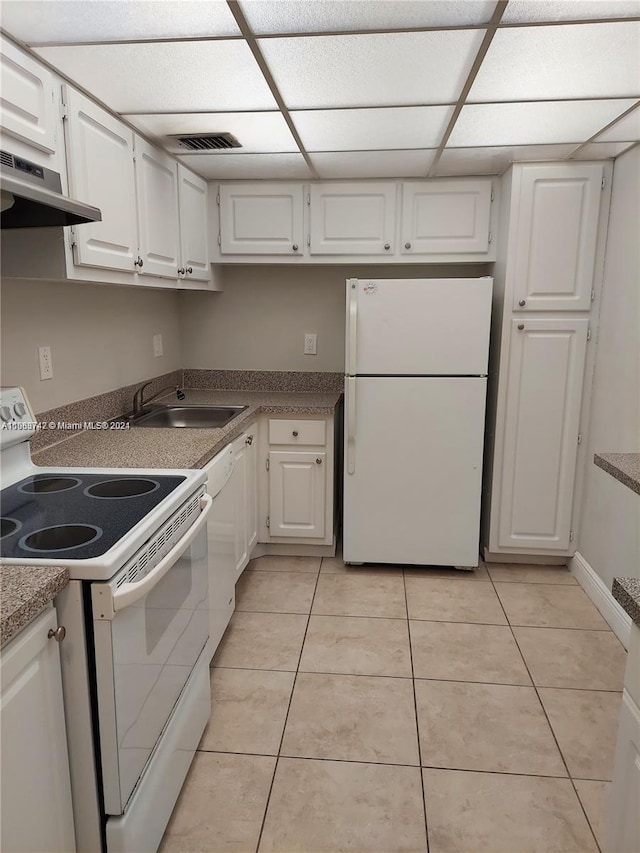 kitchen featuring ventilation hood, white appliances, light tile patterned floors, and white cabinets