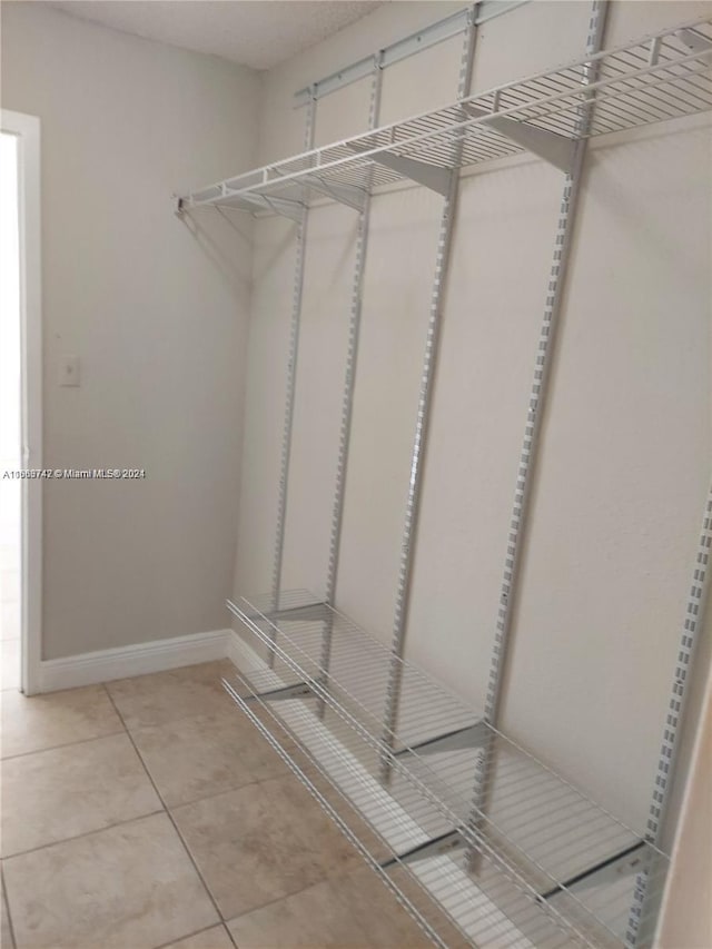 walk in closet with tile patterned floors