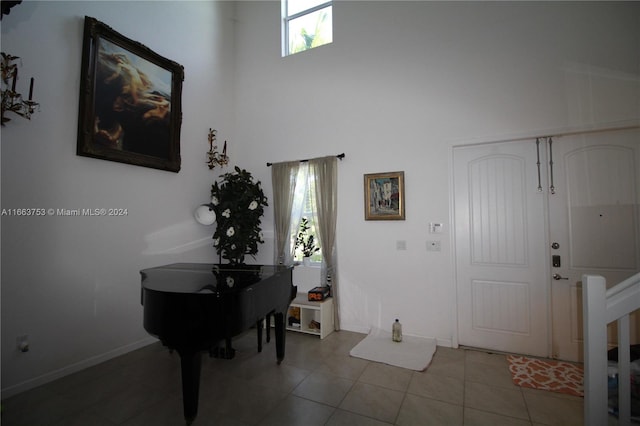 tiled entryway with a high ceiling