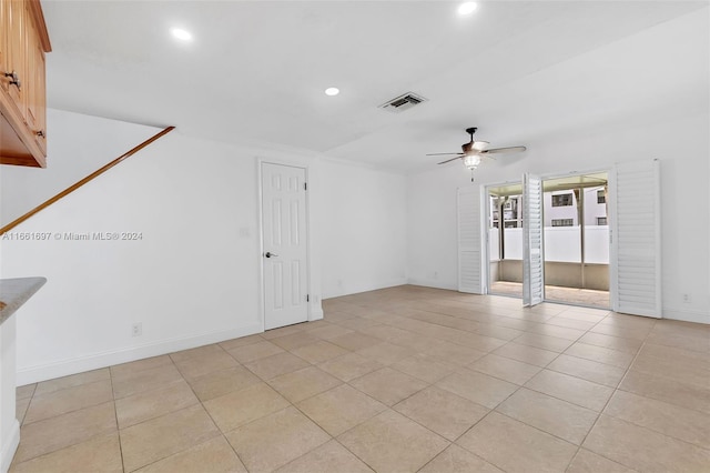 interior space with ceiling fan and light tile patterned flooring