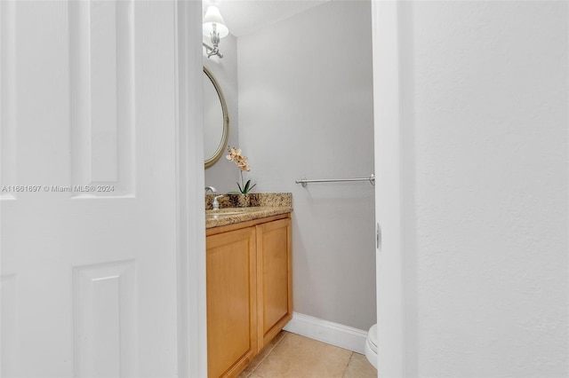 bathroom featuring tile patterned flooring, vanity, and toilet