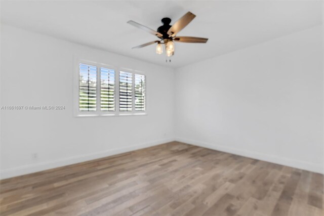 spare room featuring ceiling fan and light hardwood / wood-style floors