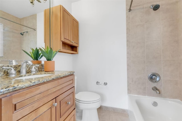 full bathroom with tiled shower / bath combo, vanity, toilet, and tile patterned floors