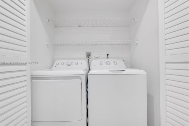 laundry area with washing machine and clothes dryer