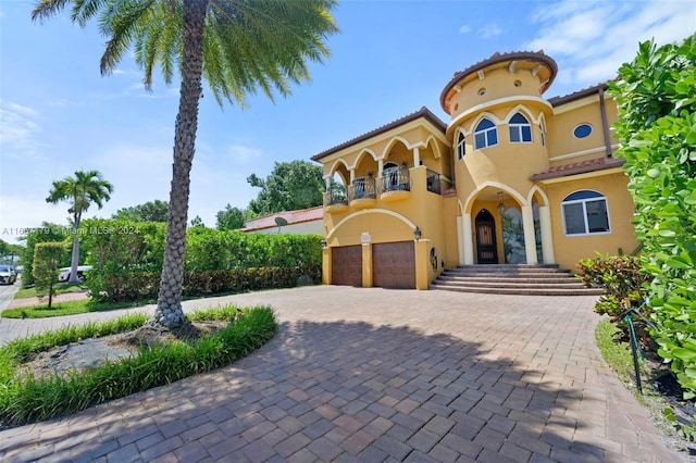 9580 Byron Ave, Surfside, FL 33154 - mediterranean / spanish home with a balcony, a garage, stucco siding, and driveway