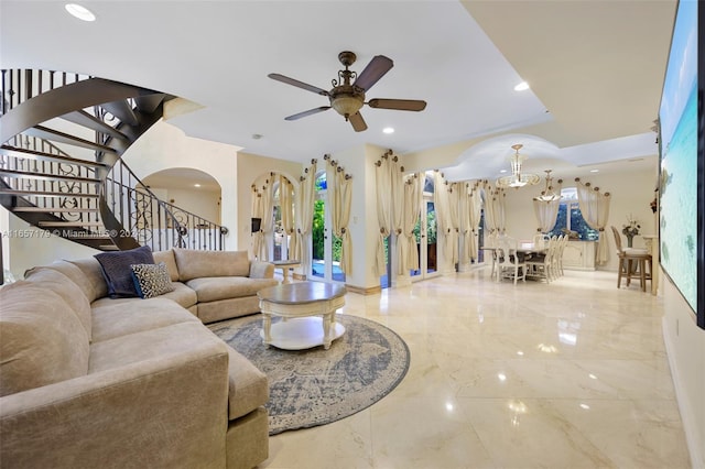 9580 Byron Ave, Surfside, FL 33154 - living area featuring marble tiled floors, arched walkways, stairway, ceiling fan, and recessed lighting