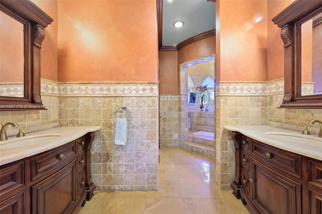 bathroom with vanity, tile walls, crown molding, and tile patterned floors