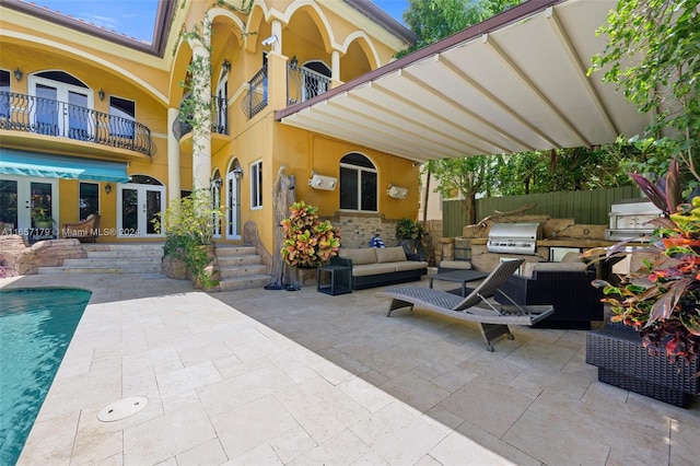 view of patio featuring an outdoor hangout area, area for grilling, and a balcony