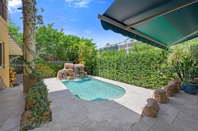 view of pool with a patio and pool water feature