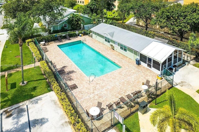 view of pool with a lawn and a patio area