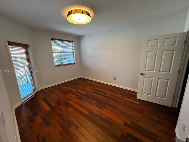 unfurnished room with dark hardwood / wood-style floors