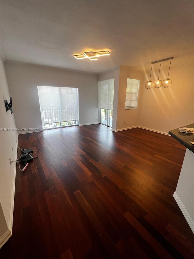 unfurnished living room with dark hardwood / wood-style floors