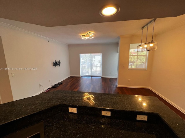 unfurnished room with crown molding and dark wood-type flooring