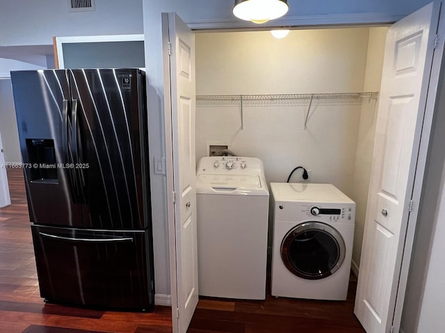 laundry room featuring washing machine and dryer and dark wood-type flooring