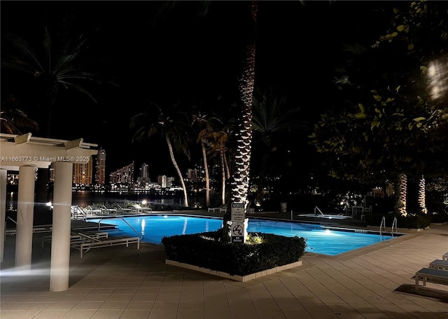 pool at night with a patio