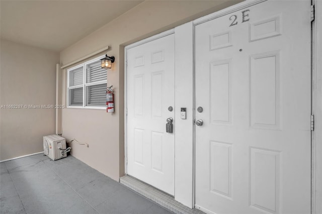 property entrance with stucco siding