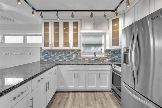 kitchen with stainless steel appliances, white cabinets, and a sink