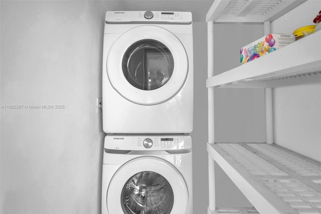 washroom featuring laundry area and stacked washer / dryer