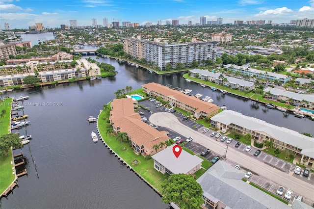 birds eye view of property with a city view and a water view