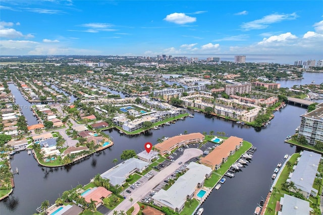 birds eye view of property with a water view and a city view