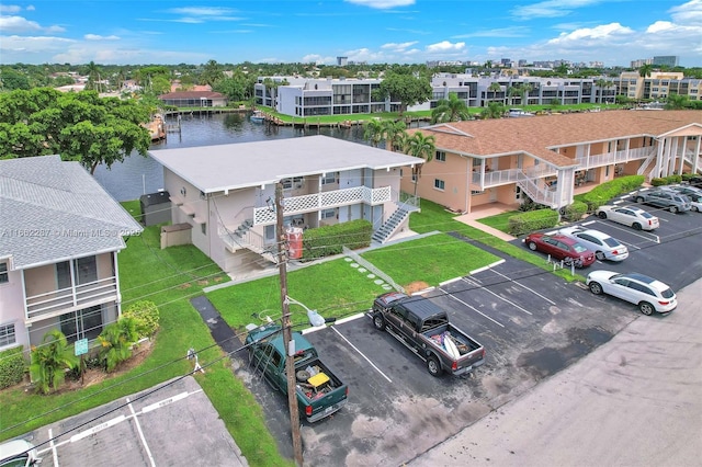 drone / aerial view featuring a residential view and a water view